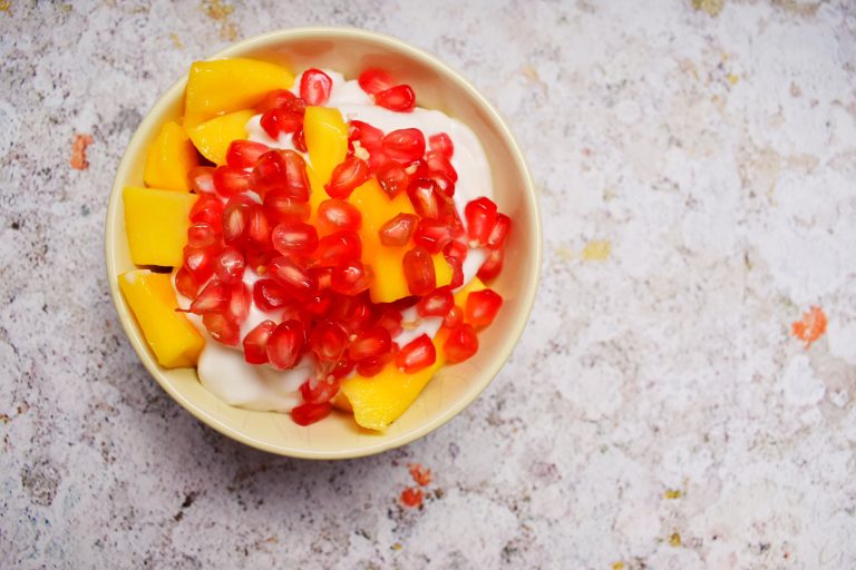 Coconut yoghurt with mango and pomegranate